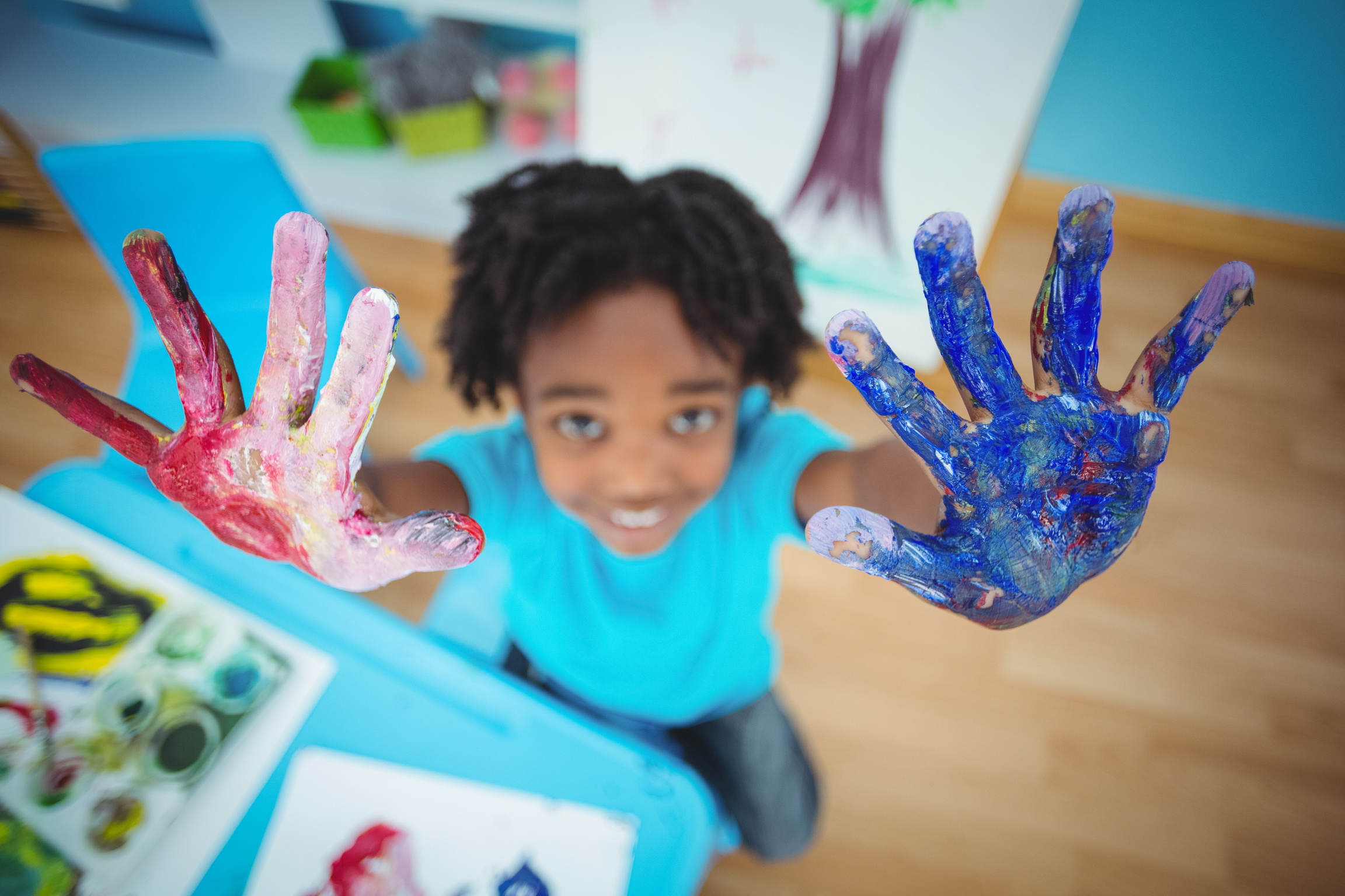 Happy kid enjoying arts and crafts painting